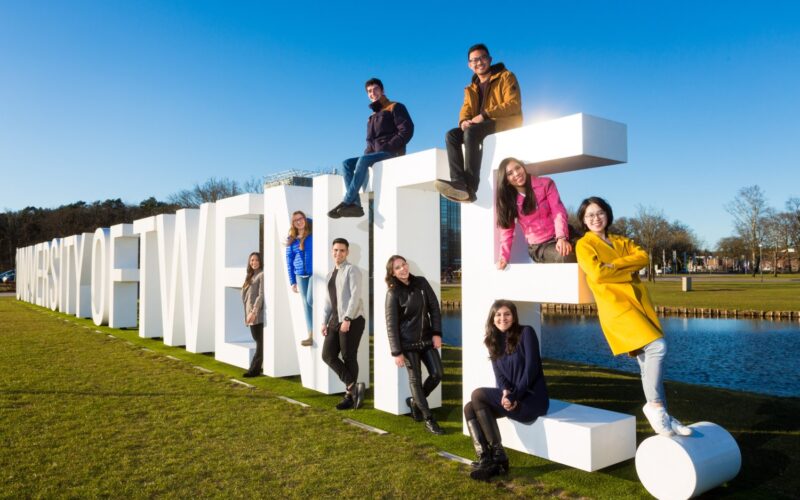international students at the University of Twente campus in the Netherlands celebrating admission through the fully funded University of Twente Scholarship 2026 for master’s programs.
